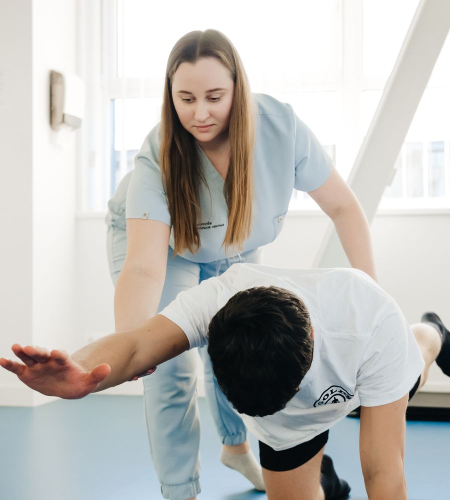 Rehabilitation specialist helping a patient exercise