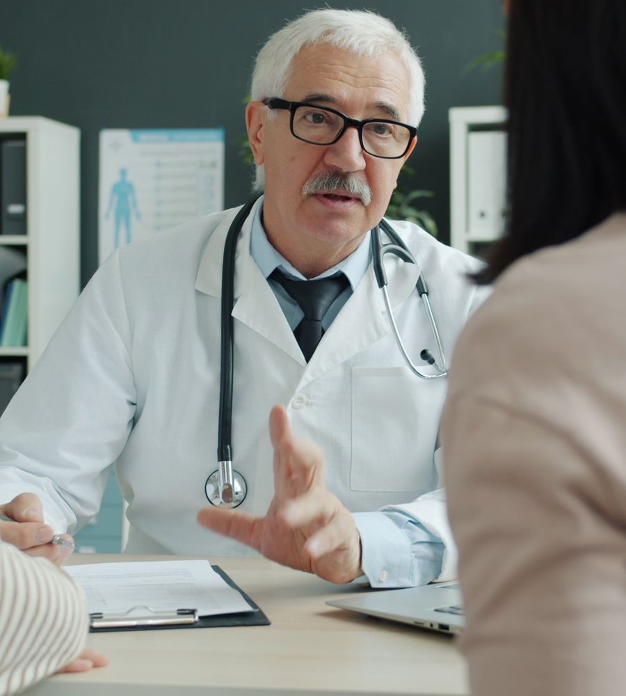 Doctor consulting with a family in a clinic