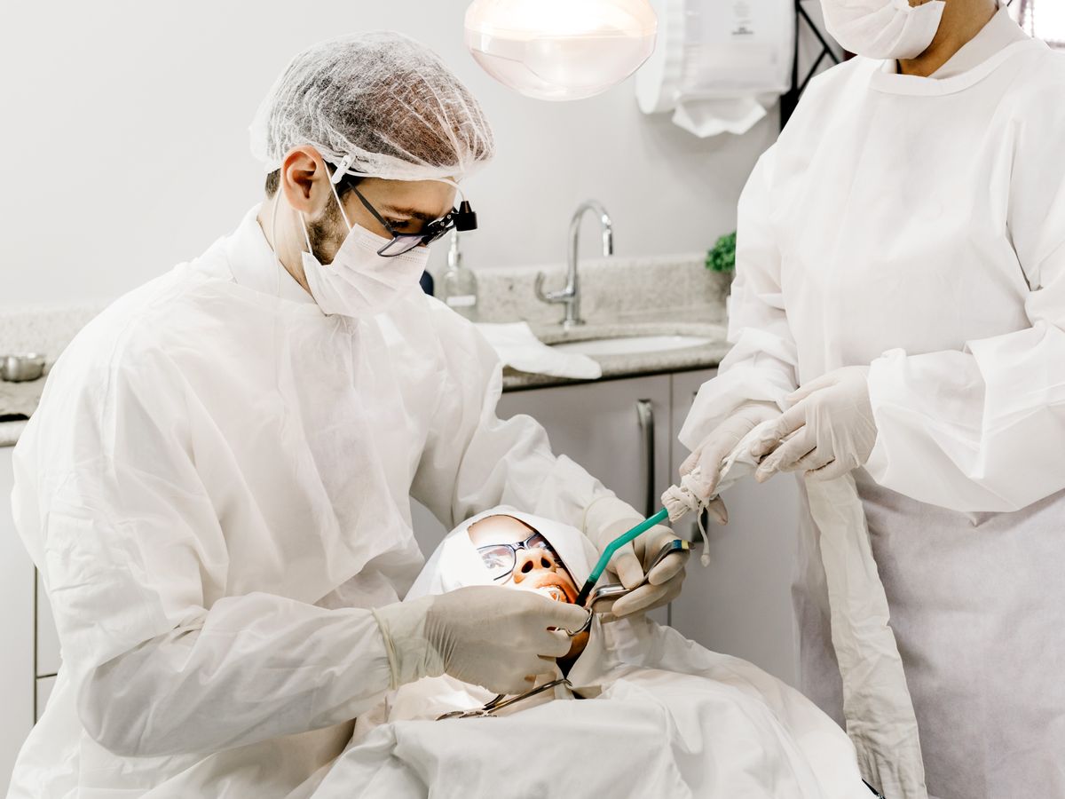 Dentist and assistant treating a patient