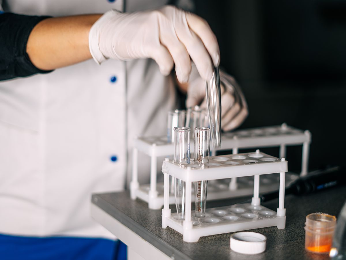 Lab technician handling sample tubes